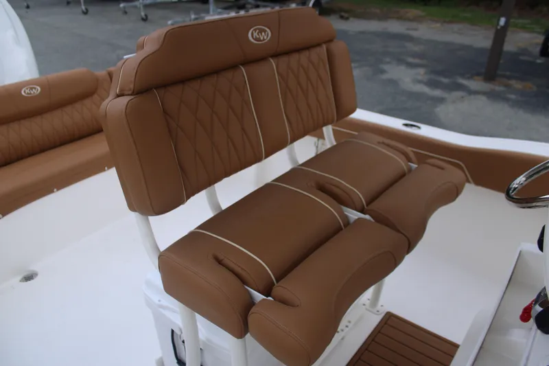 Slide: The Image of 2026 Key West 239 FS boat with luxurious brown seating and white accents. - 13
