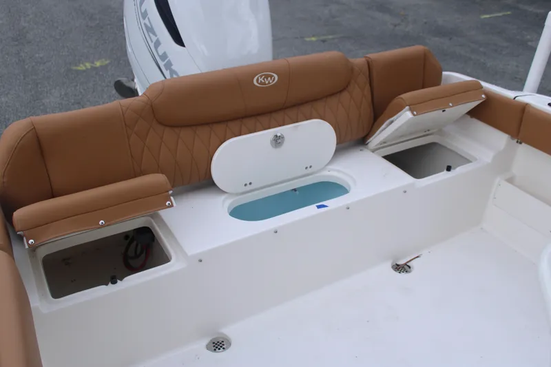 Slide: The Image of 2026 Key West 239 FS boat interior with tan seating and storage compartments. - 15