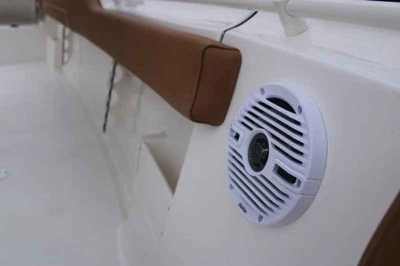 Slide: The Image of 2026 Key West 239 FS boat interior with speaker and cushioned seating. - 16