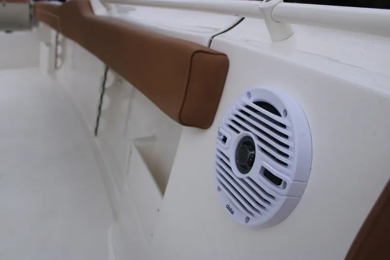 Slide: The Image of 2026 Key West 239 FS boat interior with speaker and brown cushioned rail. - 17