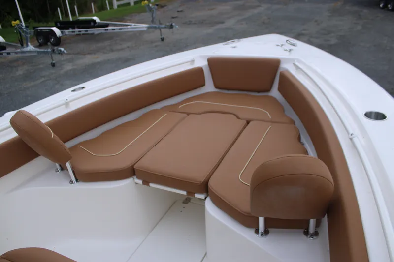 Slide: The Image of 2026 Key West 239 FS boat interior with brown cushioned seating. - 18