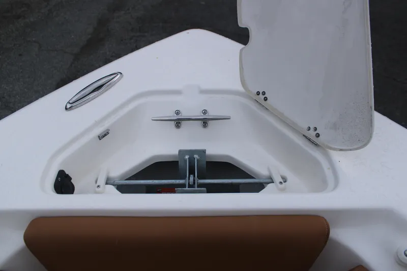 Slide: The Image of Open anchor compartment on 2026 Key West 239 FS boat, featuring stainless steel hardware. - 23