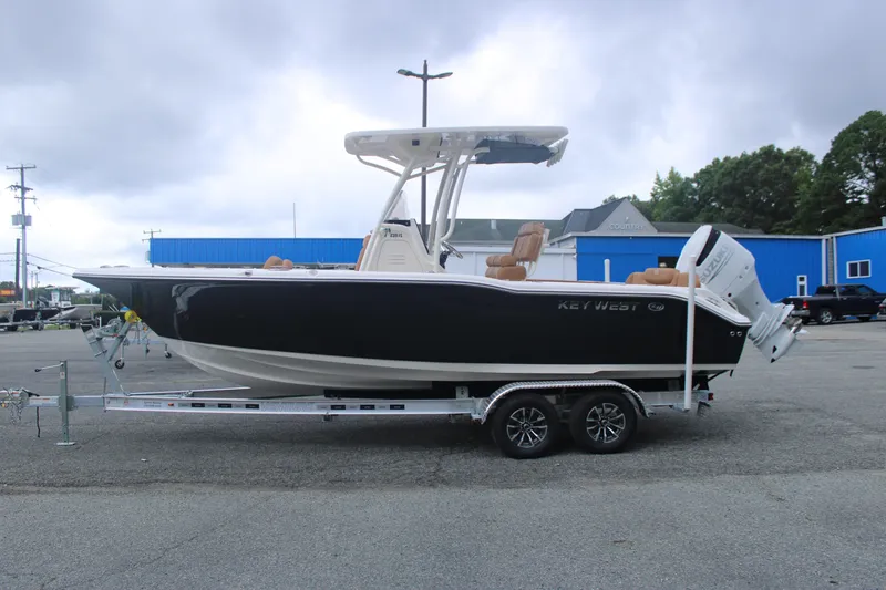 Slide: The Image of 2026 Key West 239 FS boat on trailer, parked outdoors, with overcast sky. - 3