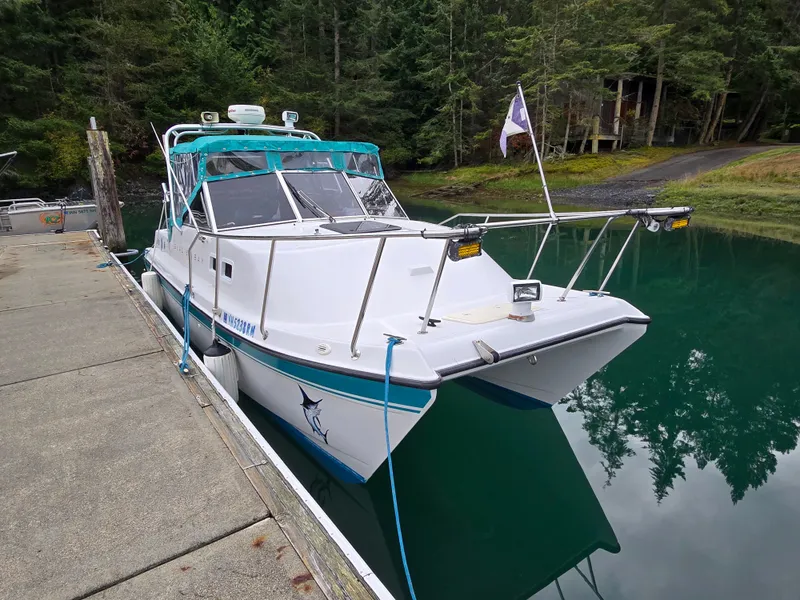 The Image of 1997 Glacier Bay 252 boat docked in a serene forested marina. - 1