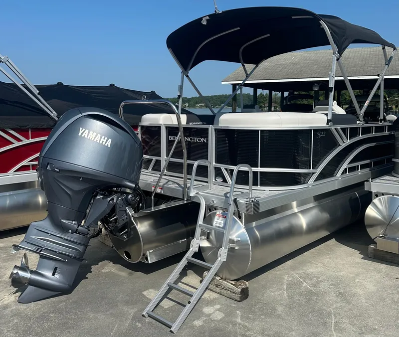 Slide: The Image of 2025 Bennington 22 SSRSE pontoon boat with Yamaha outboard motor, docked under a canopy. - 3