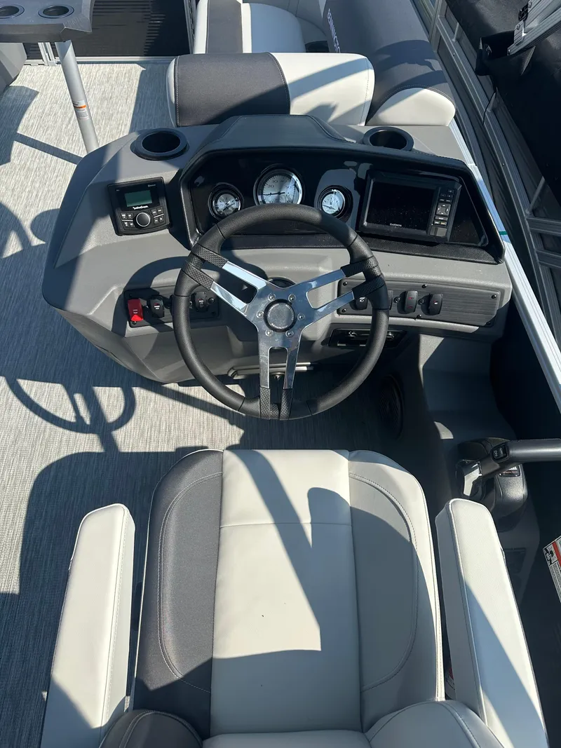 Slide: The Image of 2025 Bennington 22 SSRSE boat dashboard with steering wheel and gauges. - 7