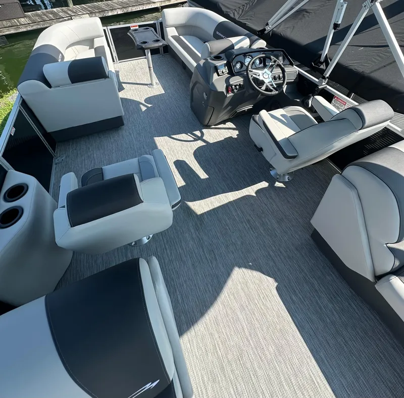 Slide: The Image of Interior of a 2025 Bennington 22 SSRSE pontoon boat with luxurious seating and modern helm. - 8