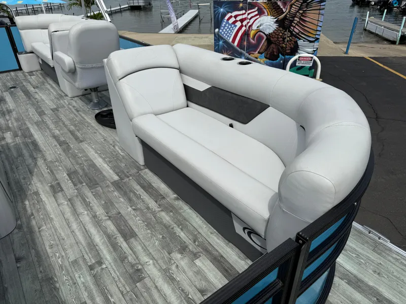Slide: The Image of 2022 Crest 220 boat interior with gray seating and wood-style flooring. - 10