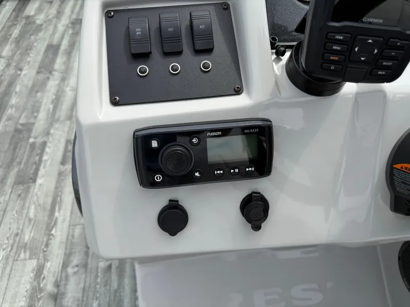 Slide: The Image of Control panel of 2022 Crest 220 boat with switches and Fusion MS-RA55 stereo system. - 18