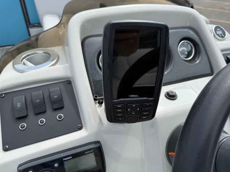 Slide: The Image of Dashboard of a 2022 Crest 220 boat featuring a Garmin navigation system. - 19