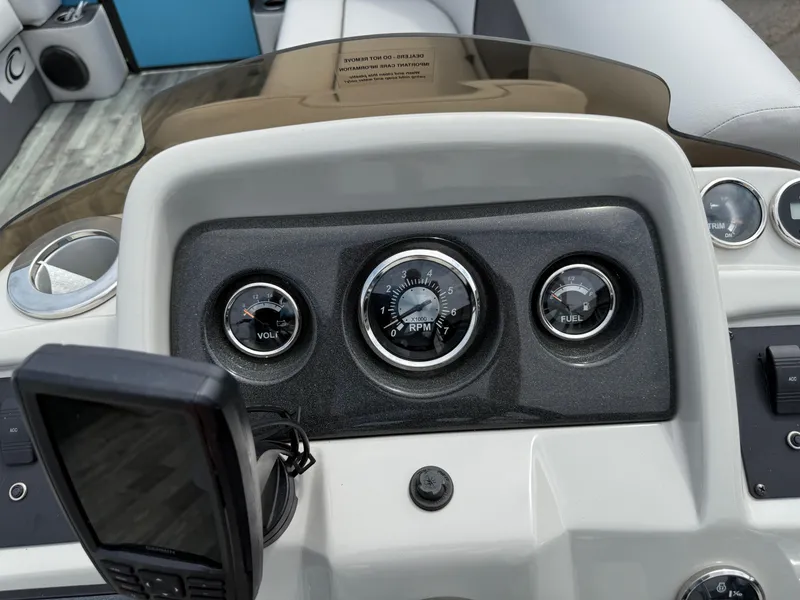 Slide: The Image of Dashboard of a 2022 Crest 220 boat featuring gauges and controls. - 20