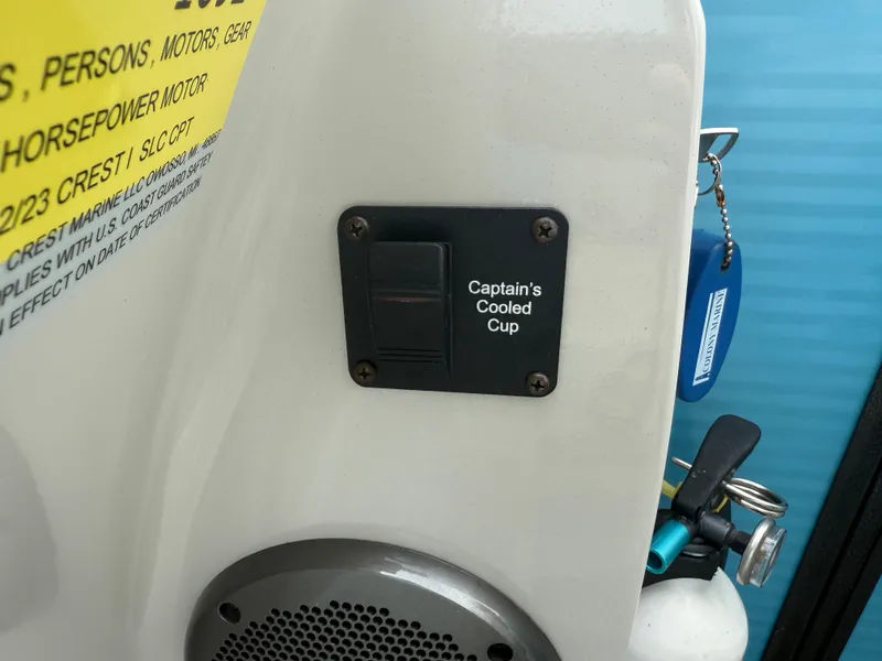 Slide: The Image of Control panel labeled "Captain's Cooled Cup" on a 2022 Crest 220 boat. - 22