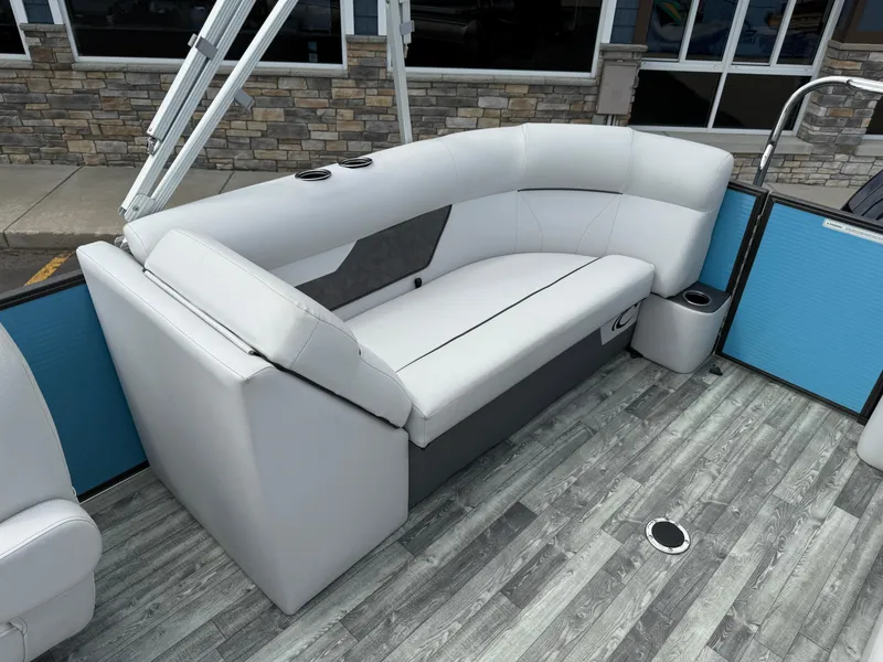 Slide: The Image of 2022 Crest 220 boat interior with gray seating and wood-style flooring. - 24