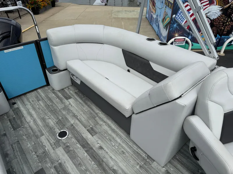 Slide: The Image of 2022 Crest 220 boat interior with gray seating and wood-style flooring. - 25