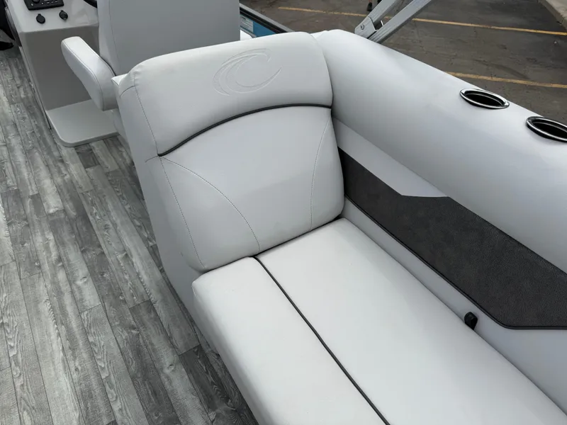 Slide: The Image of 2022 Crest 220 boat interior with gray seating and cup holders. - 28