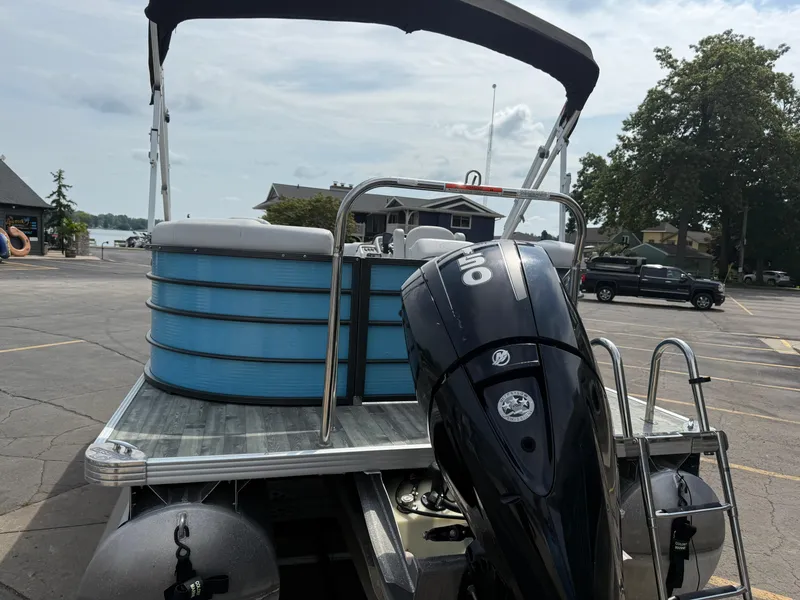 Slide: The Image of 2022 Crest 220 pontoon boat with outboard motor in a parking lot. - 7