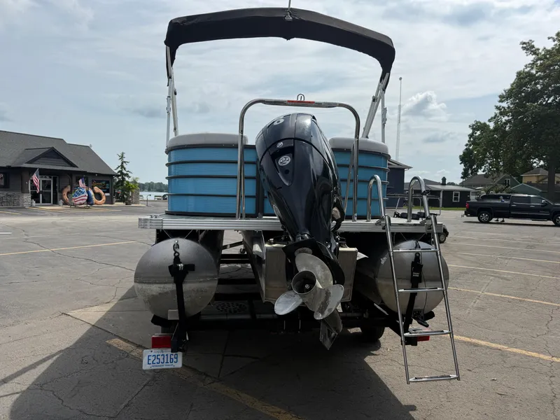 Slide: The Image of 2022 Crest 220 pontoon boat with outboard motor in parking lot. - 8