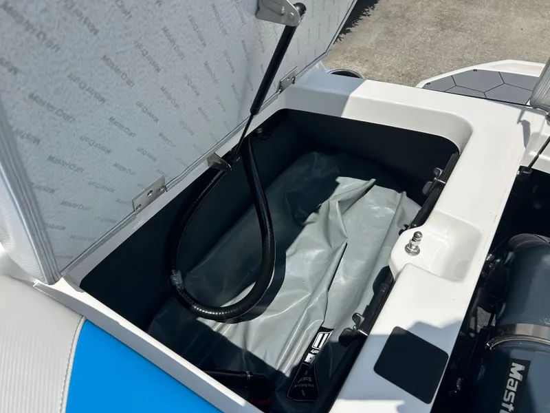 Slide: The Image of Open storage compartment in 2017 MasterCraft NXT20 boat, showing interior details and components. - 10