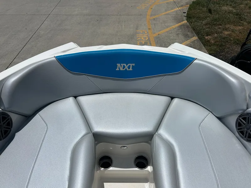 Slide: The Image of 2017 MasterCraft NXT20 boat interior with gray seating and blue accent. - 15