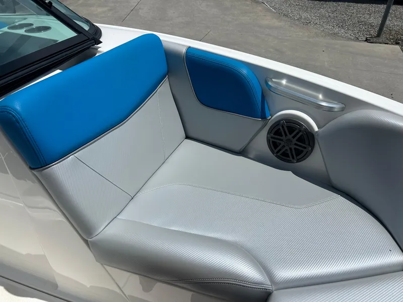 Slide: The Image of 2017 MasterCraft NXT20 boat interior with blue and gray seating, featuring a speaker. - 16