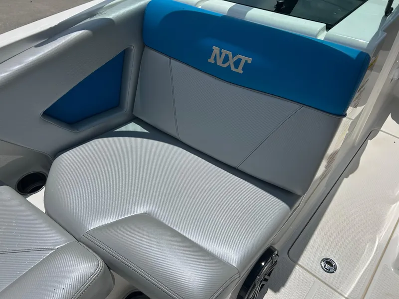 Slide: The Image of 2017 MasterCraft NXT20 boat interior with gray and blue seating. - 17