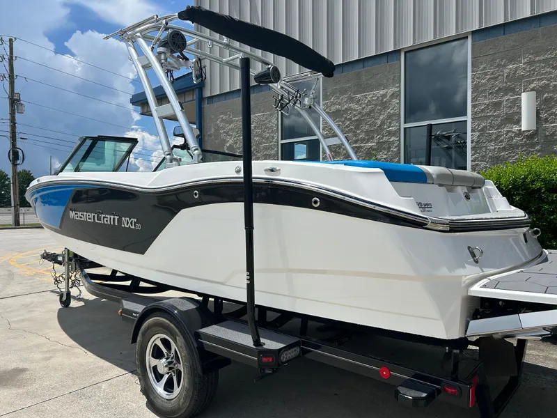 Slide: The Image of 2017 MasterCraft NXT20 boat on trailer, parked outdoors near a building. - 3