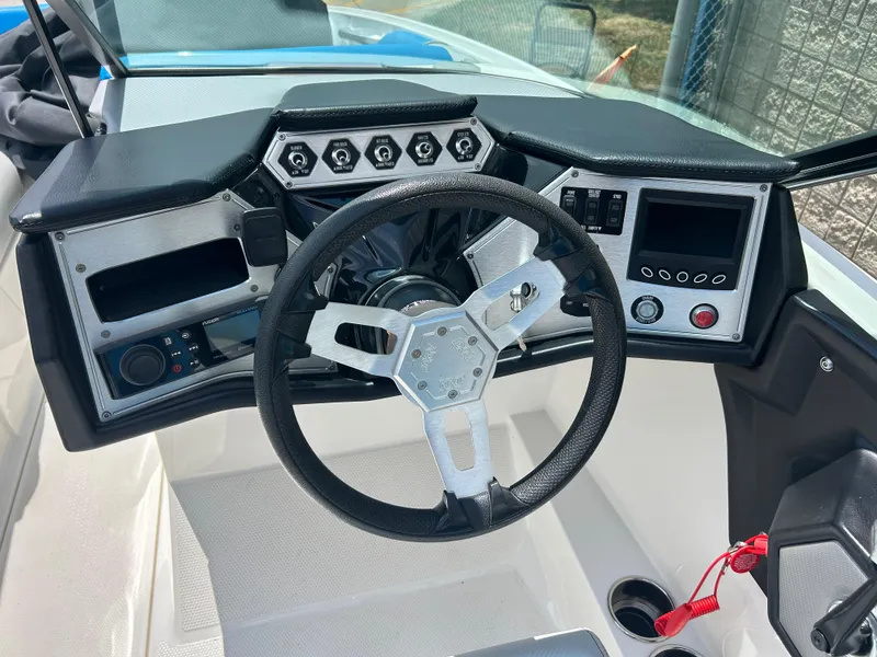 Slide: The Image of 2017 MasterCraft NXT20 boat dashboard with steering wheel and control panel. - 8
