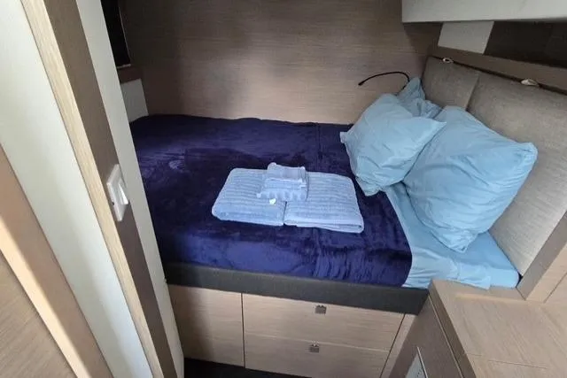 Slide: The Image of Cozy bedroom in 2022 Fountaine Pajot Tanna 47 yacht with blue bedding. - 12