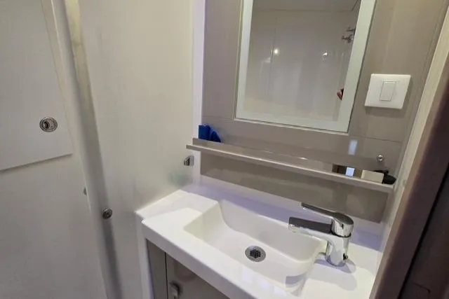Slide: The Image of Bathroom sink area in 2022 Fountaine Pajot Tanna 47 yacht, featuring modern fixtures. - 16