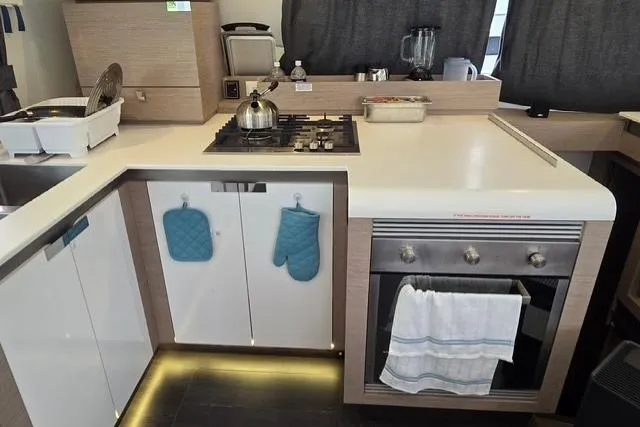 Slide: The Image of Modern kitchen in 2022 Fountaine Pajot Tanna 47 yacht with stove and oven. - 27
