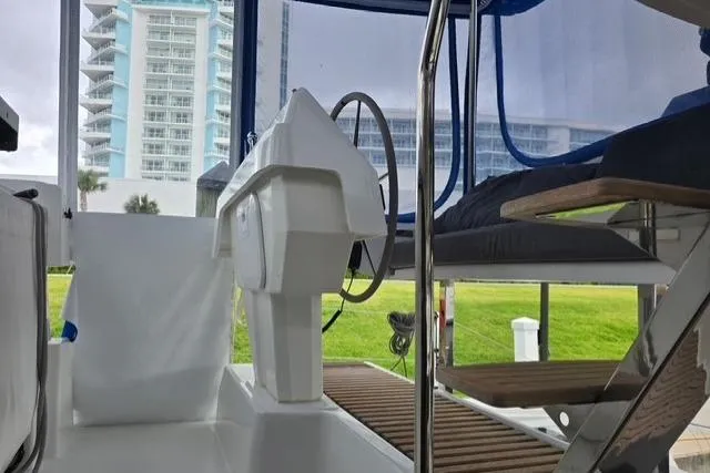 Slide: The Image of 2022 Fountaine Pajot Tanna 47 yacht helm with modern design and cityscape backdrop. - 29