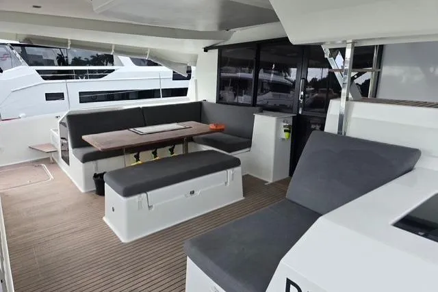 Slide: The Image of 2022 Fountaine Pajot Tanna 47 yacht interior with modern seating and dining area. - 3