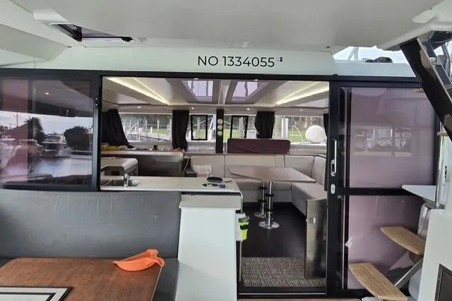 Slide: The Image of Interior view of 2022 Fountaine Pajot Tanna 47 catamaran, featuring modern seating and sleek design. - 4
