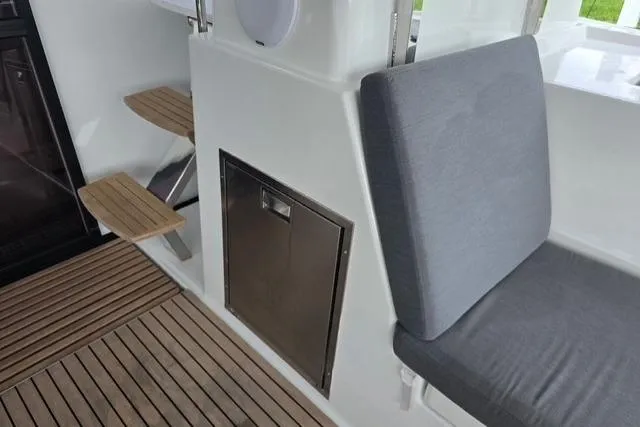 Slide: The Image of Fountaine Pajot Tanna 47 yacht interior, featuring wooden steps and cushioned seating, 2022 model. - 5