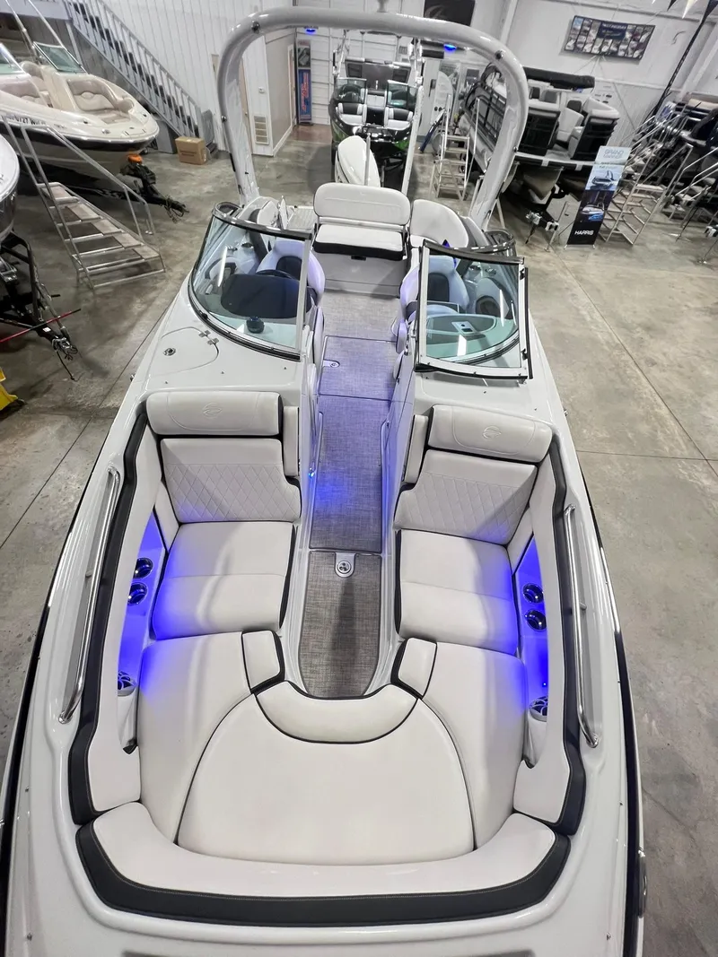 Slide: The Image of 2020 Crownline Eclipse E225 XS boat interior with plush seating and blue LED lighting. - 11