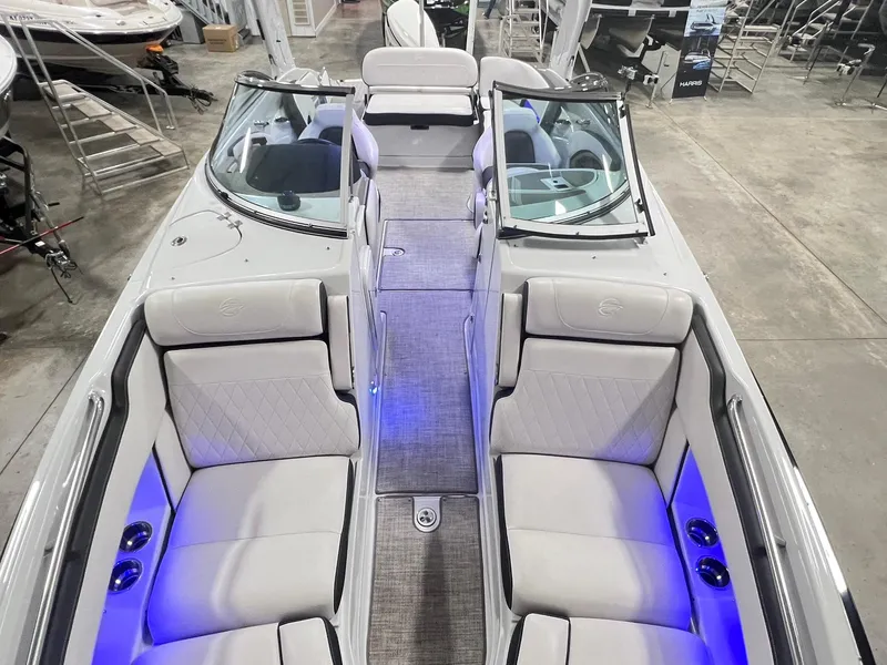 Slide: The Image of 2020 Crownline Eclipse E225 XS boat interior with plush seating and ambient lighting. - 12
