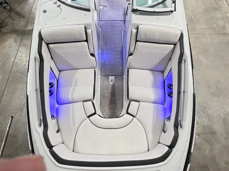 Slide: The Image of 2020 Crownline Eclipse E225 XS boat interior with white seating and blue LED lighting. - 14