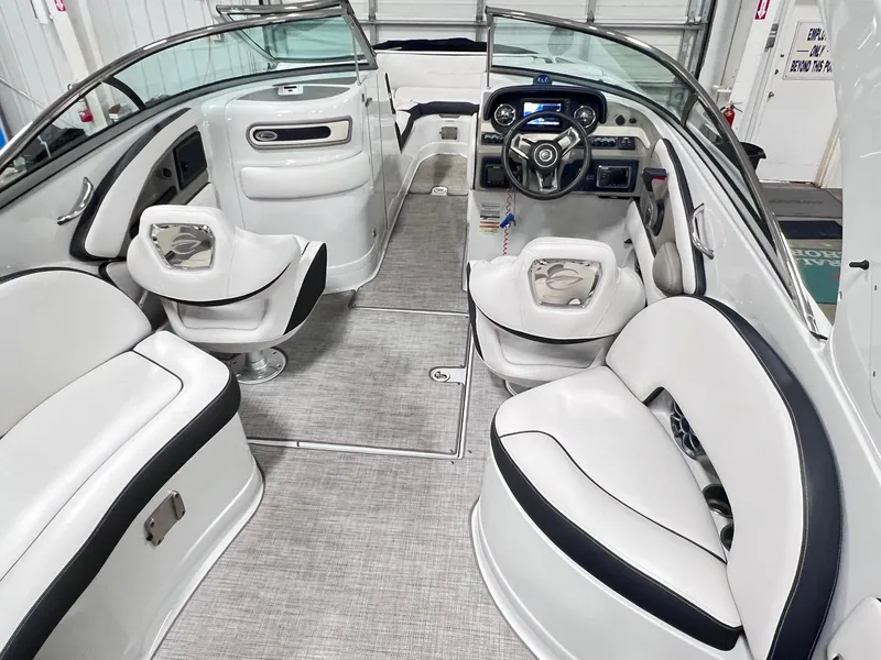 Slide: The Image of 2020 Crownline Eclipse E225 XS boat interior with sleek seating and modern dashboard. - 15