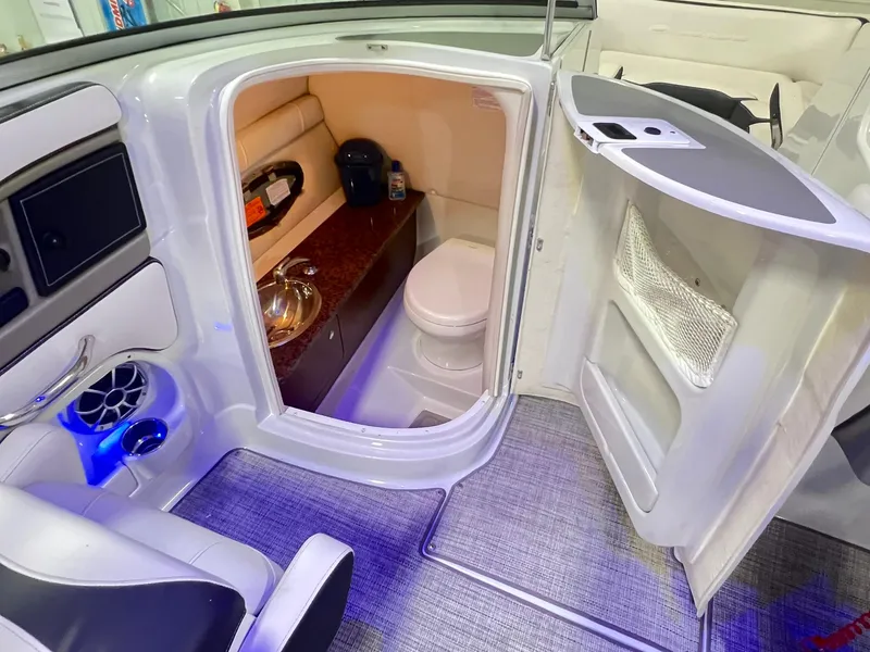 Slide: The Image of 2020 Crownline Eclipse E225 XS boat interior with compact bathroom and modern amenities. - 23