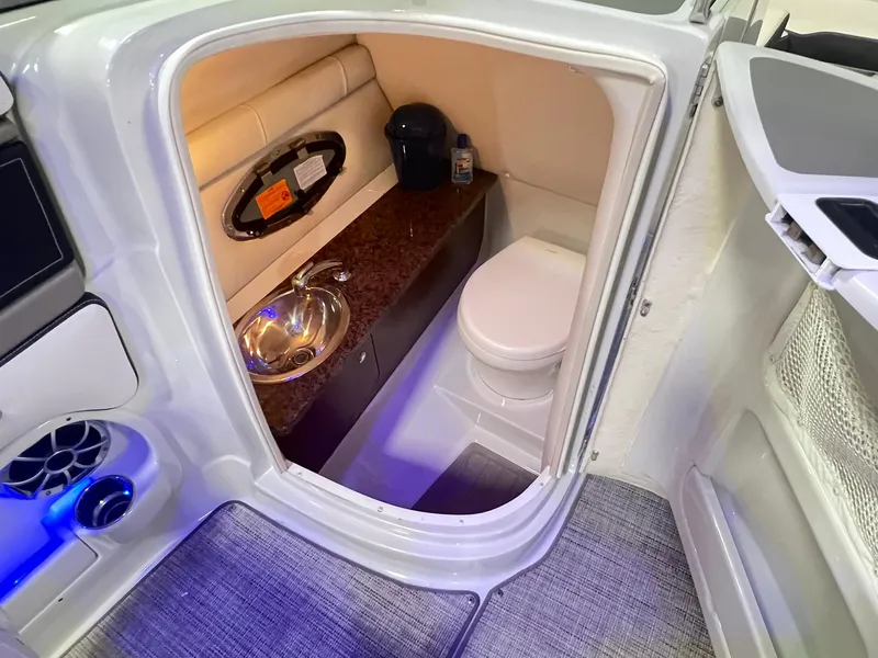 Slide: The Image of 2020 Crownline Eclipse E225 XS boat interior with compact bathroom and sink. - 24
