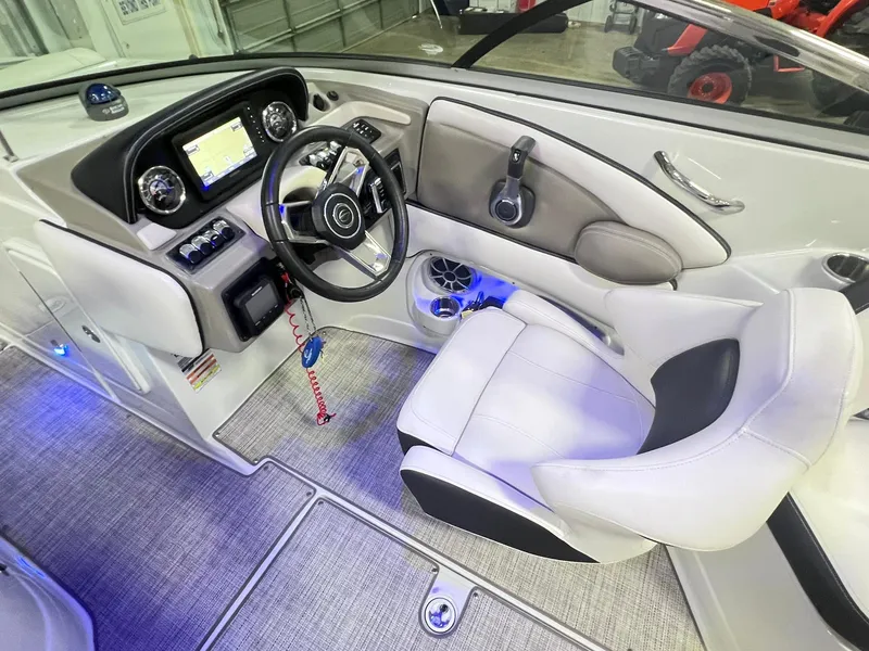 Slide: The Image of 2020 Crownline Eclipse E225 XS boat interior with modern dashboard and comfortable seating. - 25