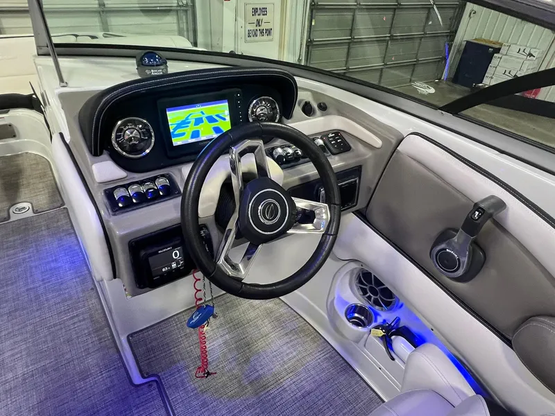 Slide: The Image of 2020 Crownline Eclipse E225 XS boat dashboard with steering wheel and navigation display. - 26