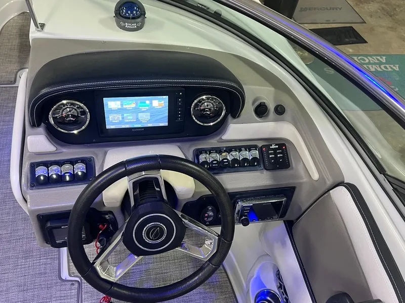 Slide: The Image of 2020 Crownline Eclipse E225 XS boat dashboard with Garmin display and steering wheel. - 27