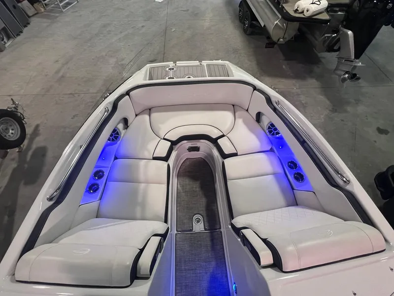 Slide: The Image of 2020 Crownline Eclipse E225 XS boat interior with white seating and blue LED lights. - 33