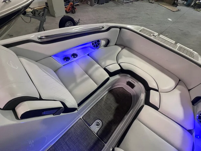 Slide: The Image of 2020 Crownline Eclipse E225 XS boat interior with white seating and blue LED lighting. - 34