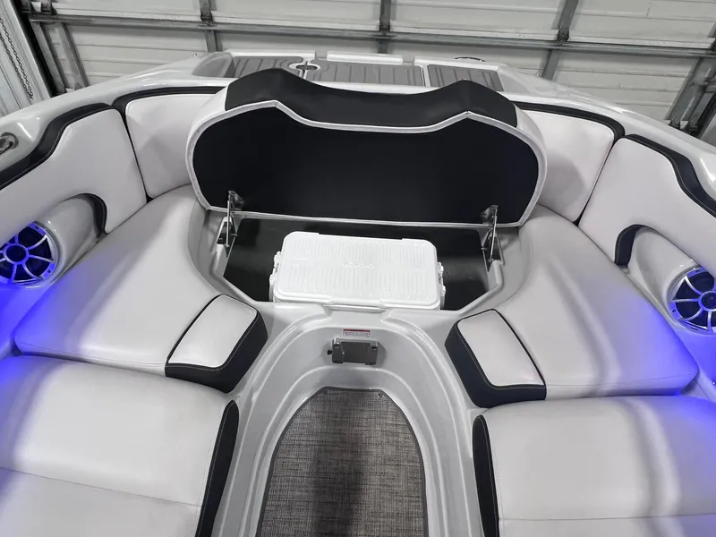Slide: The Image of 2020 Crownline Eclipse E225 XS boat interior with cushioned seating and storage compartment. - 35