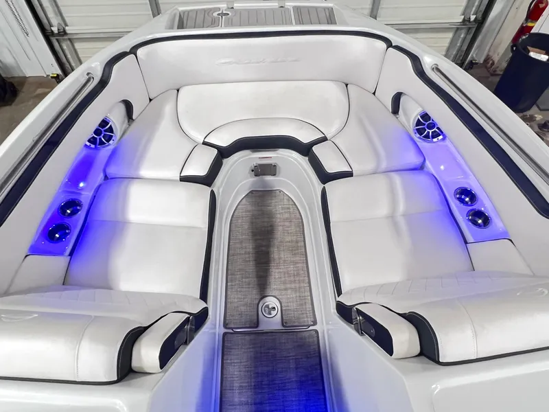 Slide: The Image of Luxurious seating area of 2020 Crownline Eclipse E225 XS boat with blue LED lighting. - 36