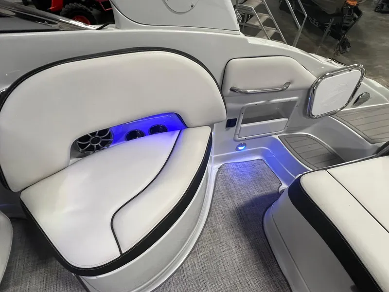 Slide: The Image of 2020 Crownline Eclipse E225 XS boat interior with white seating and blue LED lighting. - 40