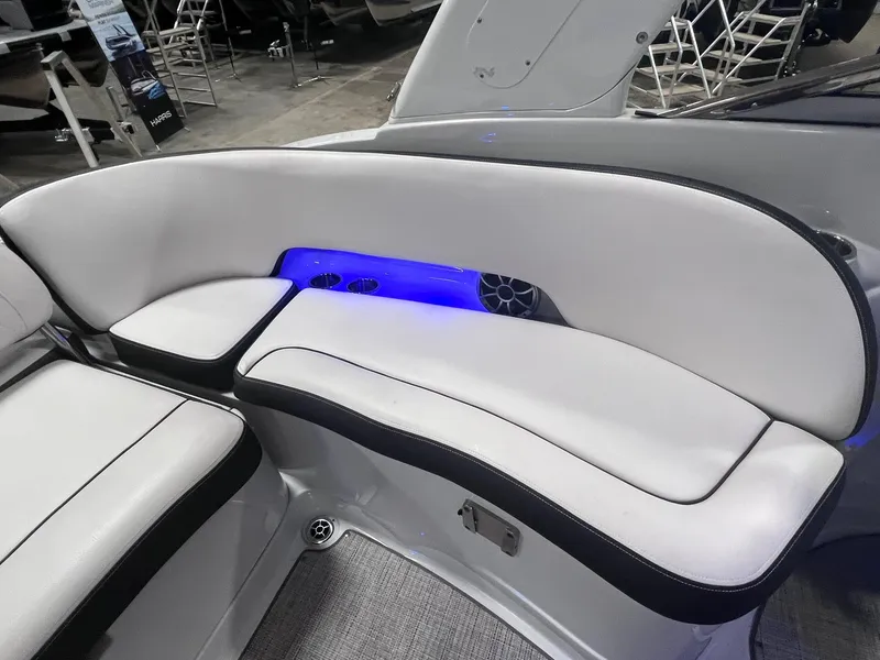 Slide: The Image of 2020 Crownline Eclipse E225 XS boat interior with white seating and blue LED lighting. - 41