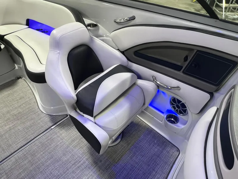 Slide: The Image of 2020 Crownline Eclipse E225 XS boat interior with white and black seating, blue LED lighting. - 42